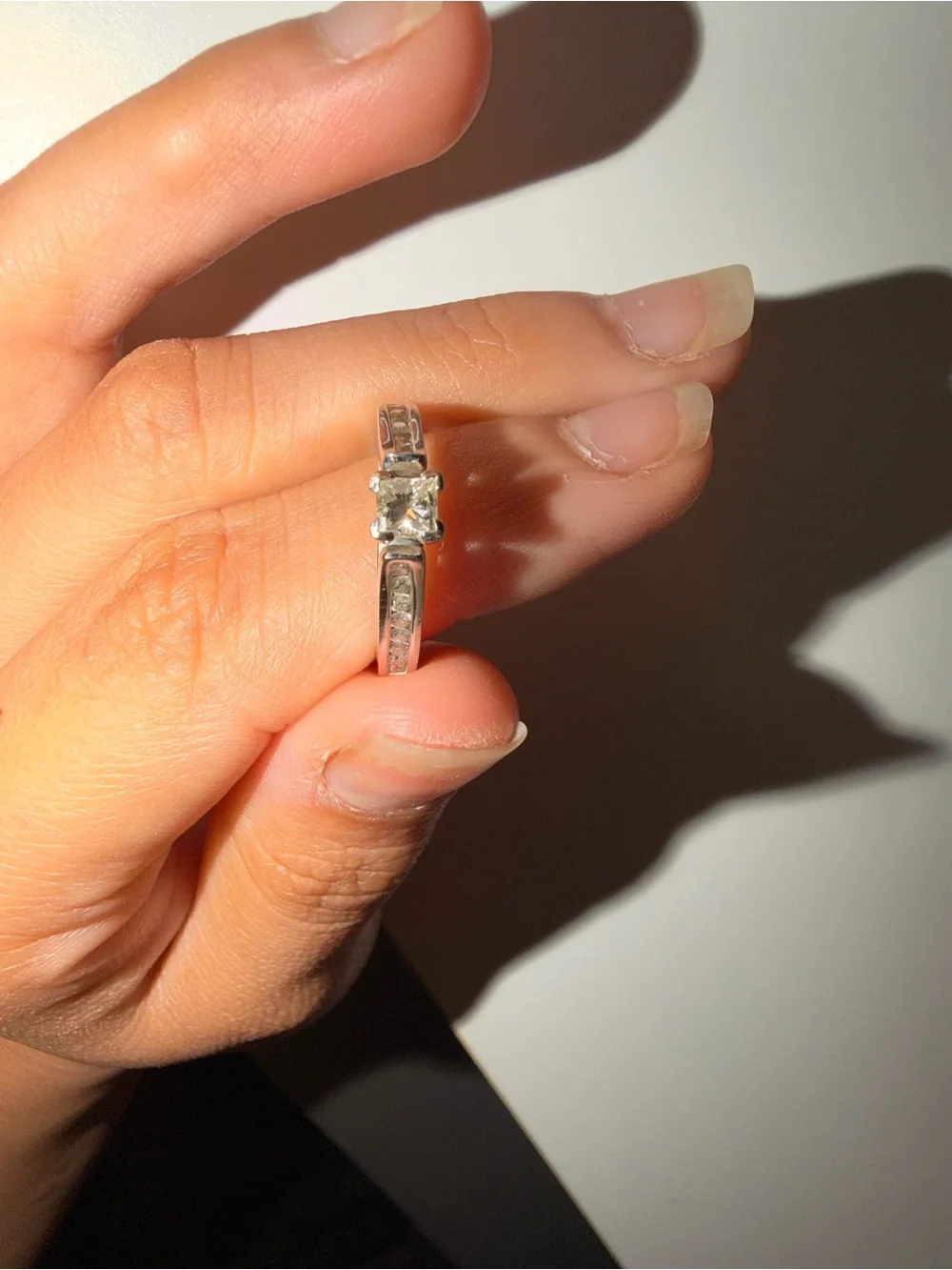 14k white gold with a 1 carat diamond princess cut ring.